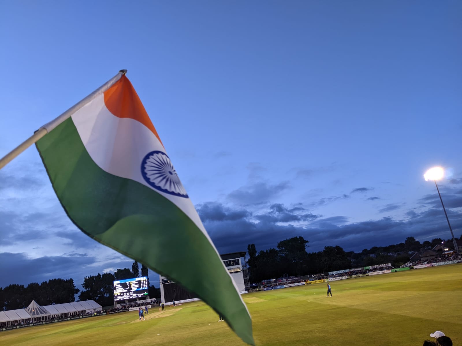Indian cricket team playing at a stadium under lights