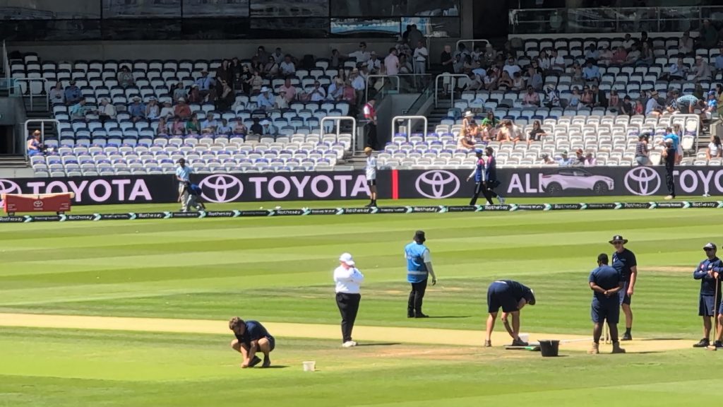Groundskeepers and match officials preparing the pitch at Lord's